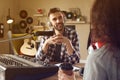 Man interviewing young woman in modern radio studio Royalty Free Stock Photo