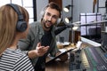 Man interviewing young woman in modern radio studio Royalty Free Stock Photo