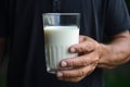 Man invites everyone to strengthen with calcium, holding a milk glass