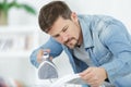 man ironing shirt on ironing board with steaming blue iron Royalty Free Stock Photo