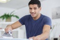man ironing shirt on ironing board with steaming blue iron Royalty Free Stock Photo