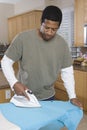 Man Ironing Shirt At Home