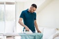 Man ironing shirt by iron at home Royalty Free Stock Photo