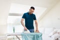 Man ironing shirt by iron at home Royalty Free Stock Photo