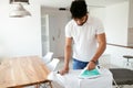 Man ironing shirt on ironing board Royalty Free Stock Photo