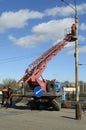 Man ironworker repairing trolleybus rigging standing on a truck mounted lift. Kyiv, Ukraine