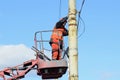 Man ironworker repairing trolleybus rigging standing on a truck mounted lift. Kyiv, Ukraine