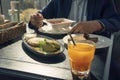 a man in a jacket is having lunch at a black table. Lunch break. Young handsome businessman eating lunch in a cafe Royalty Free Stock Photo