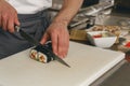 Close up of man japanese restaurant chef cooking sushi in the kitchen Royalty Free Stock Photo