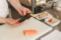 Close up of man japanese restaurant chef cooking sushi in the kitchen Royalty Free Stock Photo