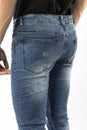 Man in jeans, denim pants close up on white background, blue jeans