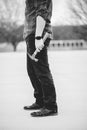 Man in jeans holding an old rusty hammer in grayscale Royalty Free Stock Photo