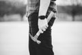 Man in jeans holding an old rusty hammer in grayscale Royalty Free Stock Photo