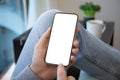 man in jeans holds golden phone with screen