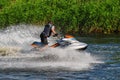 Man on jet ski turns left with much splashes Royalty Free Stock Photo