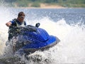 Man on jet-ski turns very fast Royalty Free Stock Photo