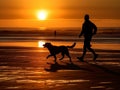 A man is jogging by the beach while being accompanied by his beloved dog.