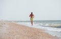 Man jogging on the desert sea line at the morning time Royalty Free Stock Photo