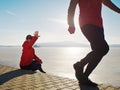 Man jogging at his girlfriend at river bank.  Hills with hot Sun Royalty Free Stock Photo