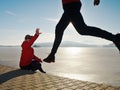 Man jogging at his girlfriend at river bank.  Hills with hot Sun Royalty Free Stock Photo