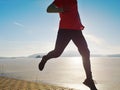 Man jogging at his girlfriend at river bank.  Hills with hot Sun Royalty Free Stock Photo