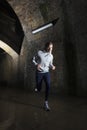 Man Jogging Through Urban Tunnel At Night Royalty Free Stock Photo