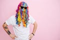 A man jokingly put on a multi-colored wig and glasses on his head