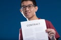 Man joyfully presents contract, symbolizes negotiation skills