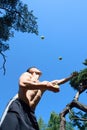 Man juggling with balls at the park