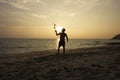 Man juggling on the beach
