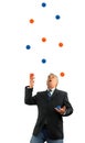 Man juggling a lot of several balls in the air representing being busy in life and business with several stressful things