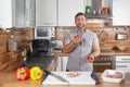 Man juggling with tomatoes in his kitchen laughing Royalty Free Stock Photo