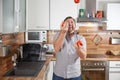Man juggling with tomatoes in his kitchen laughing Royalty Free Stock Photo