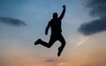 man jump high silhouette full of energy against sunset sky, energy Royalty Free Stock Photo