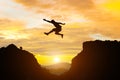 Man jump mountain cliff morning mountain sky and over silhouette