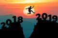 Man jump between 2018 and 2019 years. Happy new year 2019 concept for the achievement.