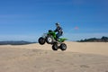 Man jumping ATV in sand dunes Royalty Free Stock Photo