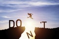 Man jumping from don`t cliff to do cliff with sunlight and blue sky for change mindset concept and never give up concept Royalty Free Stock Photo