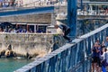 A man jumping down to River Douro from Dom Luis I Bridge in Porto, Portugal