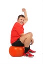Man jumping on fitness sphere Royalty Free Stock Photo