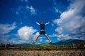 Man Jumping for Joy on a Grass Hill above horizon line Royalty Free Stock Photo