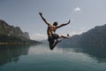 Man jumping with joy by a lake Royalty Free Stock Photo