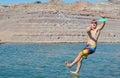 Man jumping in a lake.