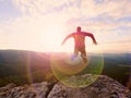 Man jumping from the mountain edge. Man jumping off a cliff without rope. Risky moment. Royalty Free Stock Photo