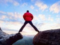 Man jumping from the mountain edge. Man jumping off a cliff without rope. Risky moment. Royalty Free Stock Photo