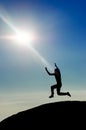 Man jumping on mountain peak silhouette Royalty Free Stock Photo
