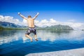 Man jumping into the ocean while on a beautiful scenic Hawaiian vacation