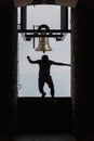 Man jumping off bell in Chapel Santa Maria degli Angeli on top of Monte Tamaro Royalty Free Stock Photo