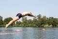 Man jumping off diving board at swimming pool