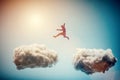 Man jumping from one cloud to another. Challenge. Royalty Free Stock Photo